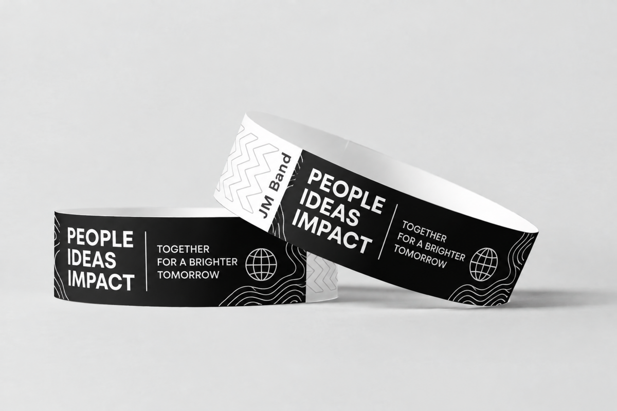 Two black paper wristbands with white print