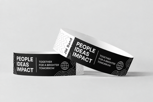 Two black paper wristbands with white print