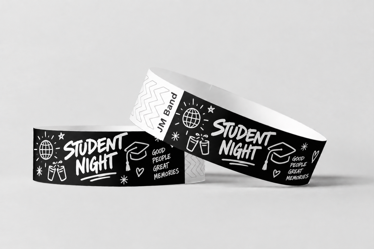 Two black paper wristbands with white student night print