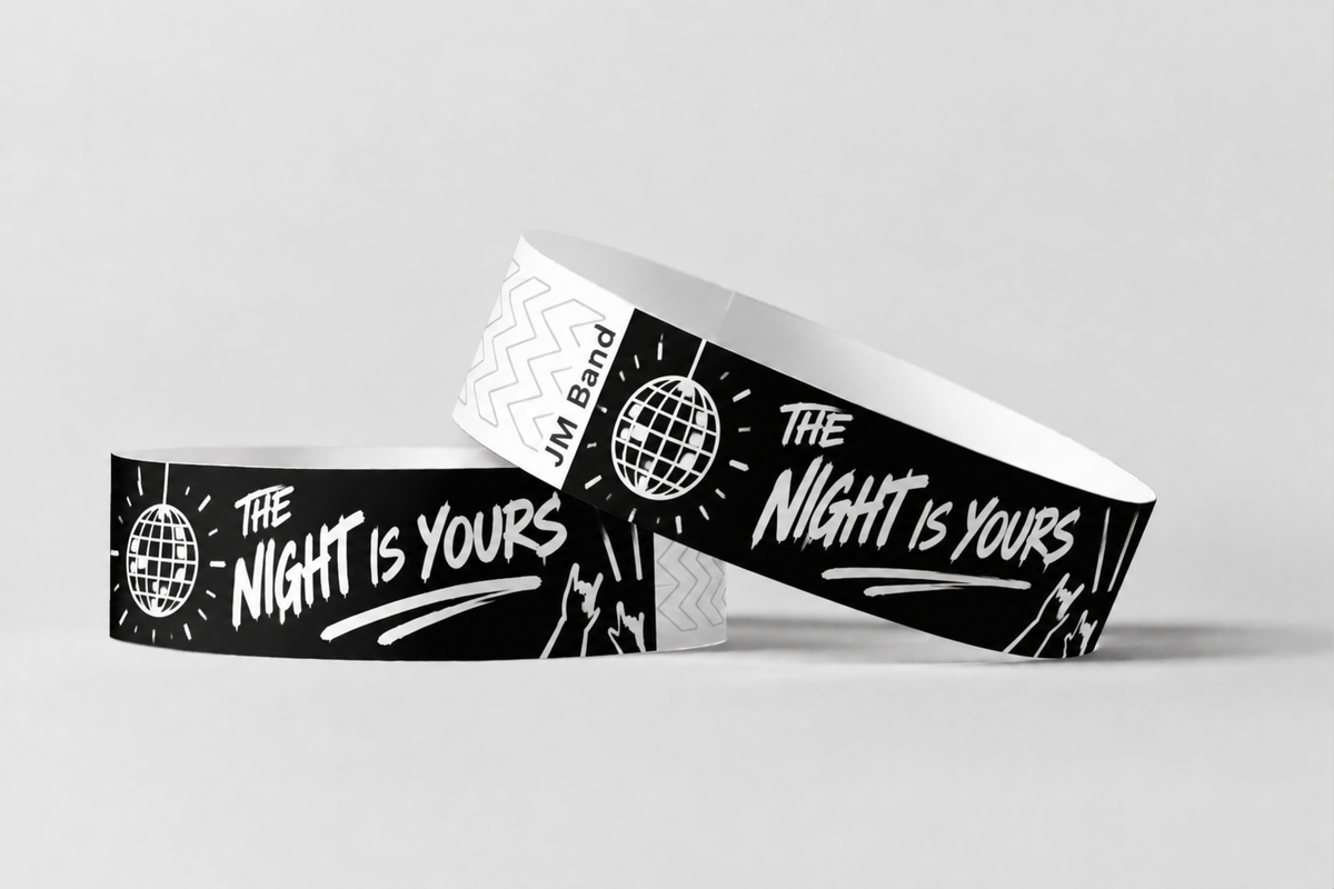 Two black paper wristbands with white party night print