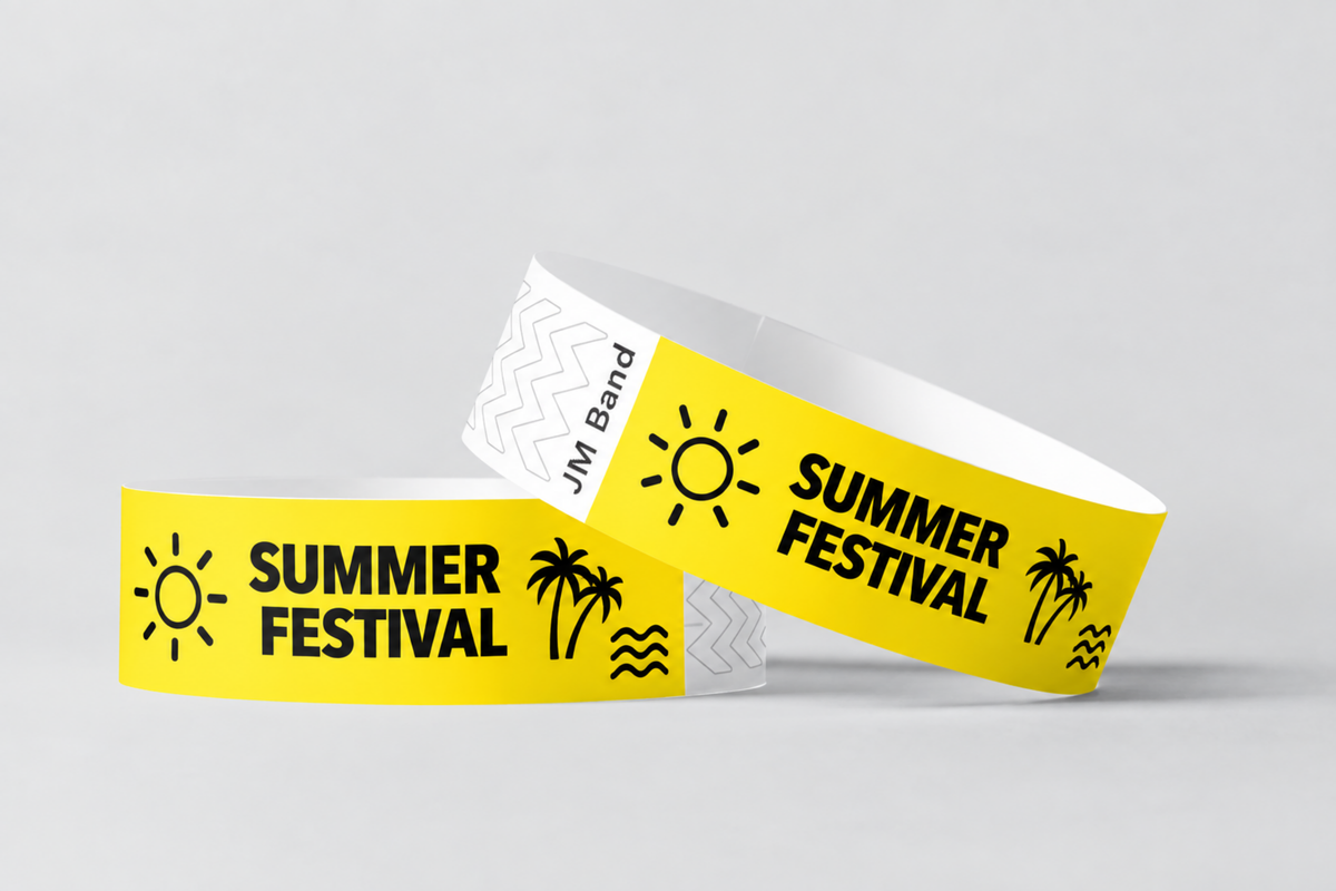 Two yellow paper wristbands printed with summer festival design
